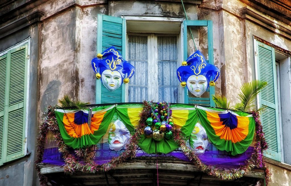 A French Quarter balcony decorated for Mardi Gras in New Orleans, LA