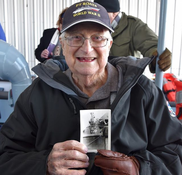 Image of a Veteran holding a picture of the PT-305